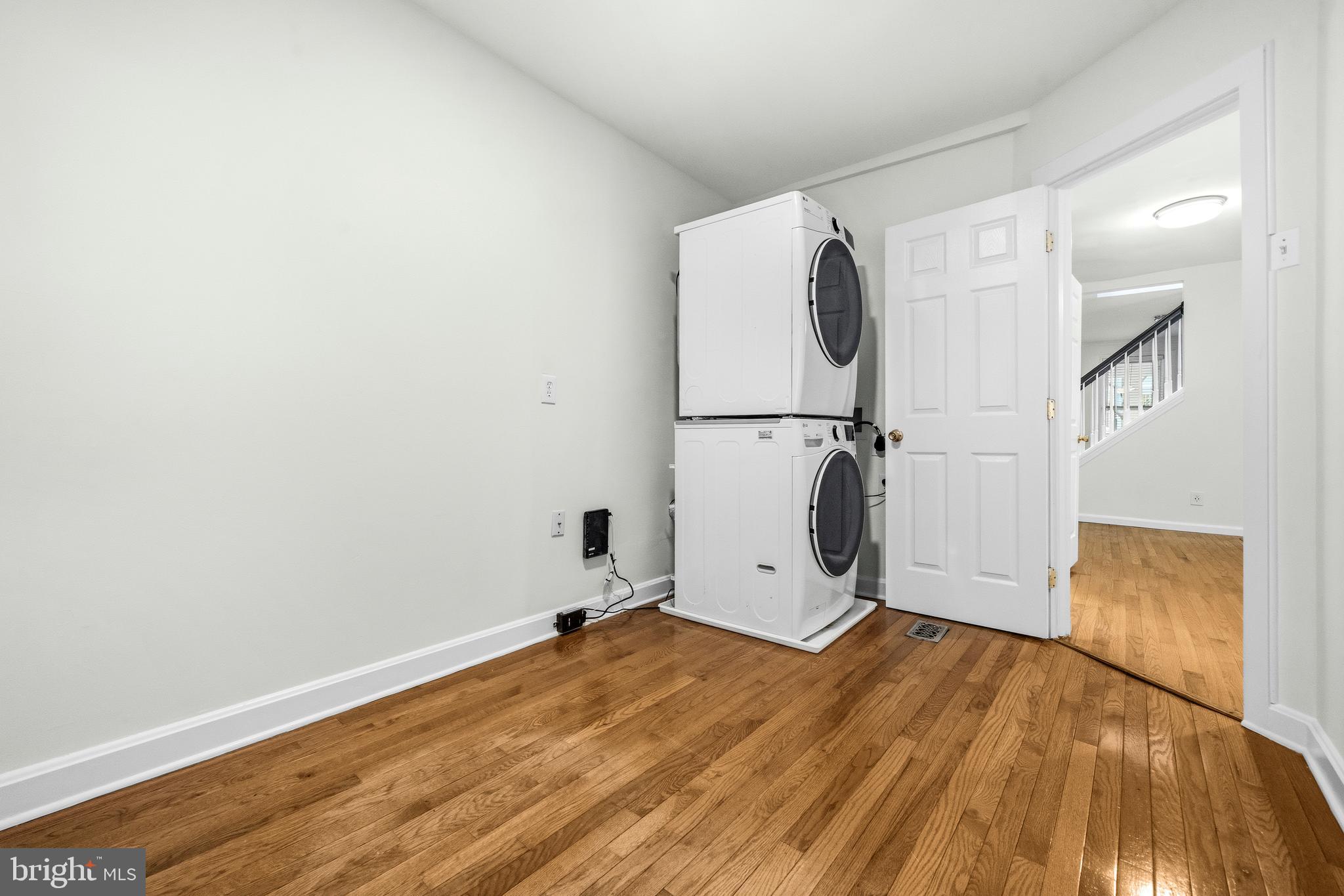 1504 Gales Street Northeast Washington, DC 20002 - Photo 11 of 24 an empty room with wooden floor and white walls