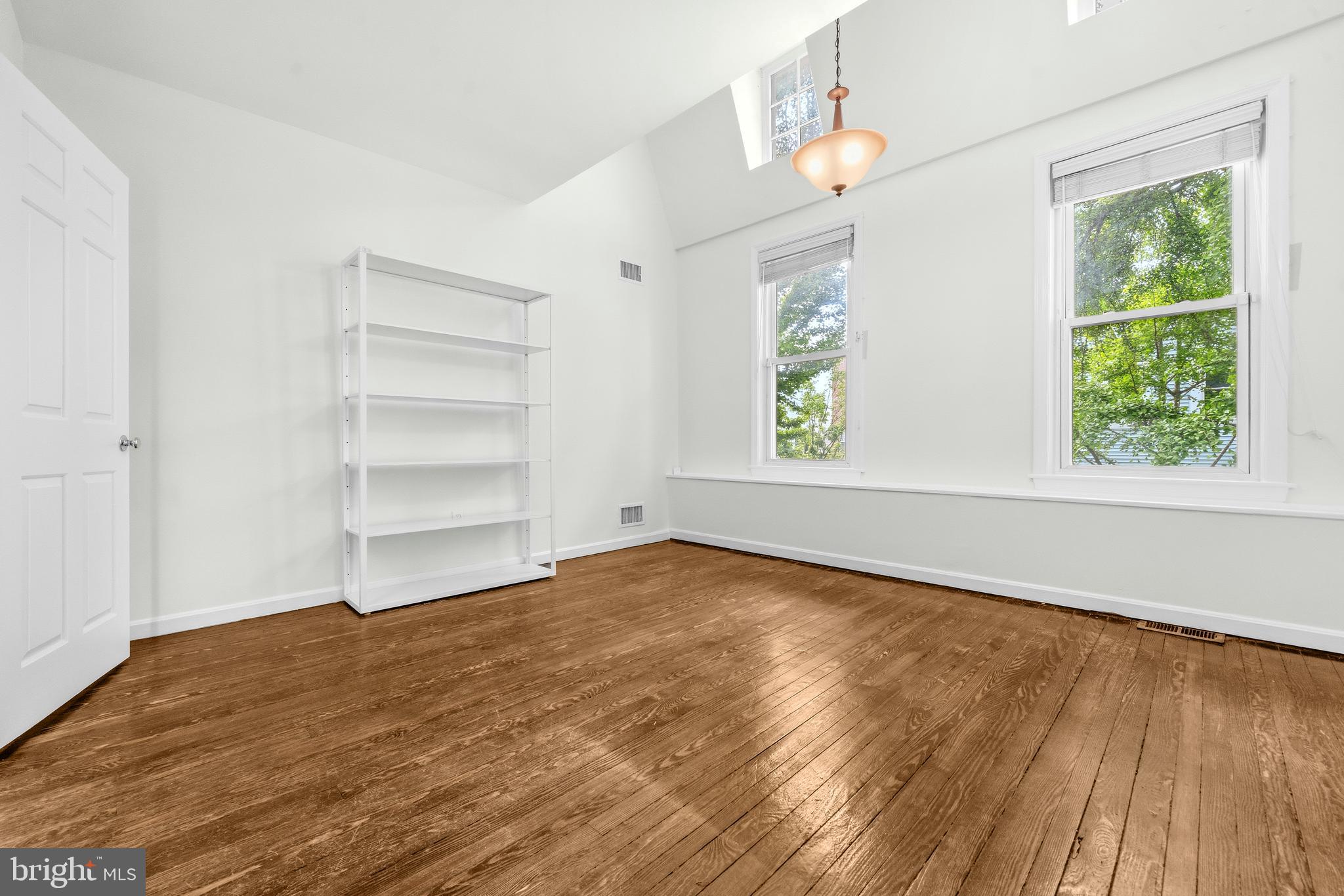 1504 Gales Street Northeast Washington, DC 20002 - Photo 15 of 24 a view of an empty room with a window and wooden floor