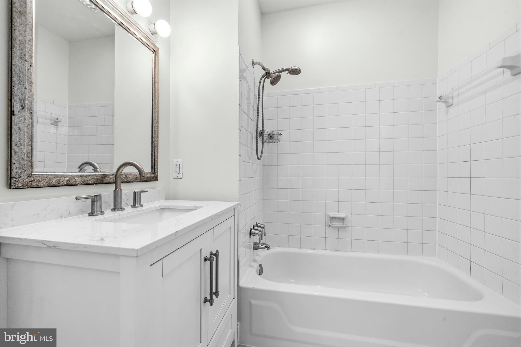 1504 Gales Street Northeast Washington, DC 20002 - Photo 17 of 24 a white bath tub sitting next to a white sink