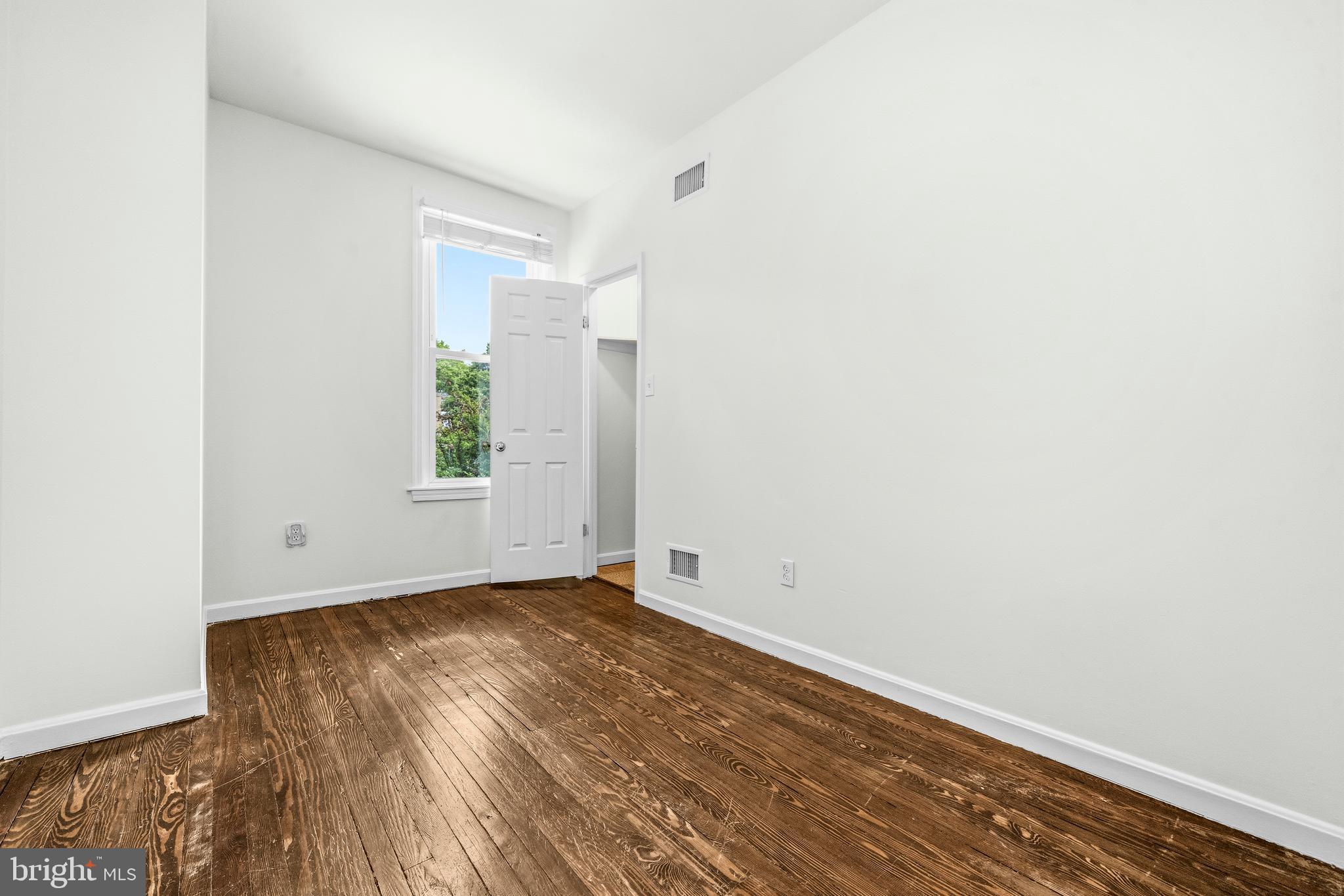 1504 Gales Street Northeast Washington, DC 20002 - Photo 18 of 24 an empty room with wooden floor and windows