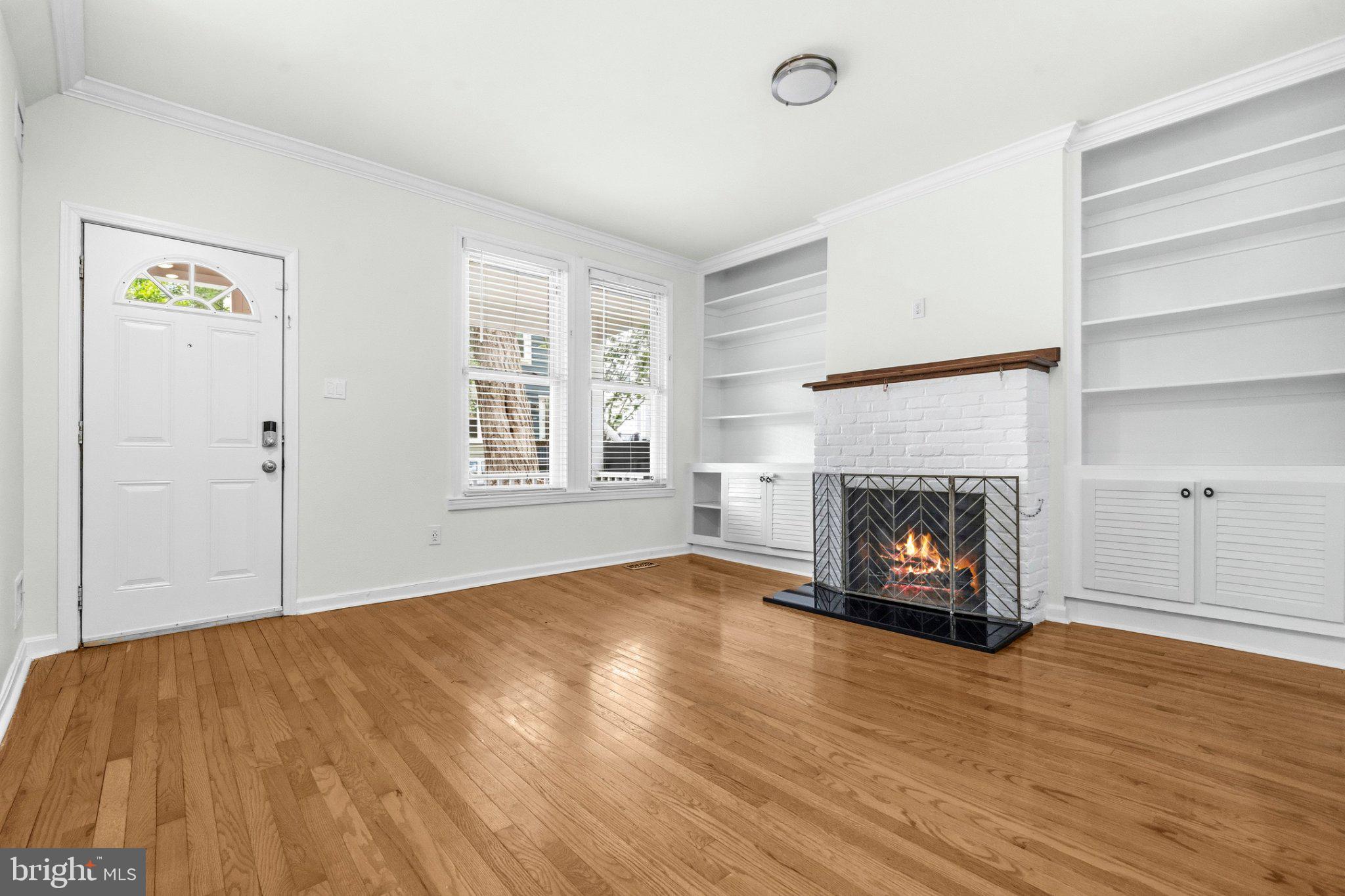 1504 Gales Street Northeast Washington, DC 20002 - Photo 3 of 24 a view of an empty room with a fireplace and a window