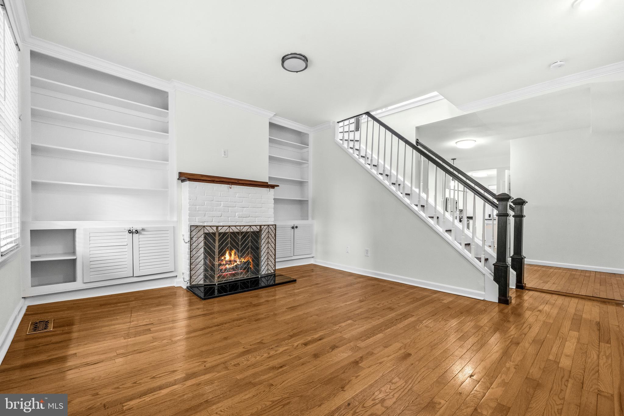 1504 Gales Street Northeast Washington, DC 20002 - Photo 4 of 24 a view of an empty room with wooden floor fireplace and a window