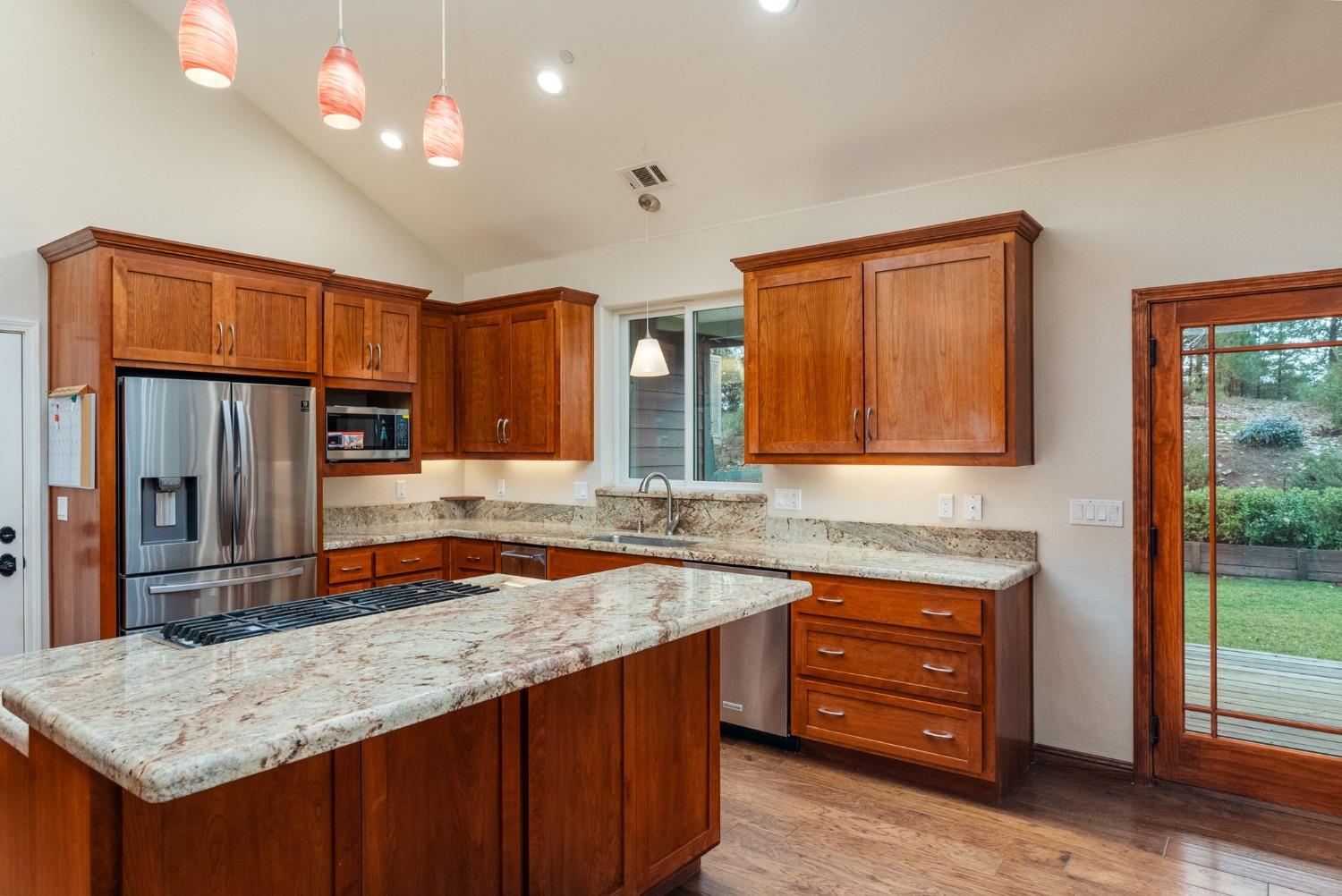 9080 El Dorado Trail Mountain Ranch, CA 95246 - Photo 21 of 48 a kitchen with stainless steel appliances granite countertop a sink stove and refrigerator