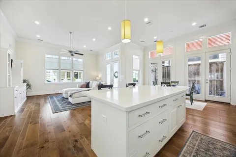 a spacious bedroom with a bed and a wooden floor