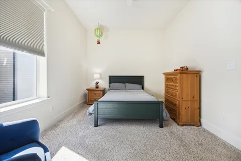 a view of a livingroom with workspace and a window