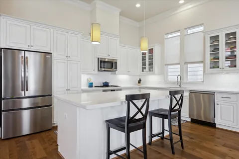 a kitchen with white cabinets and white appliances