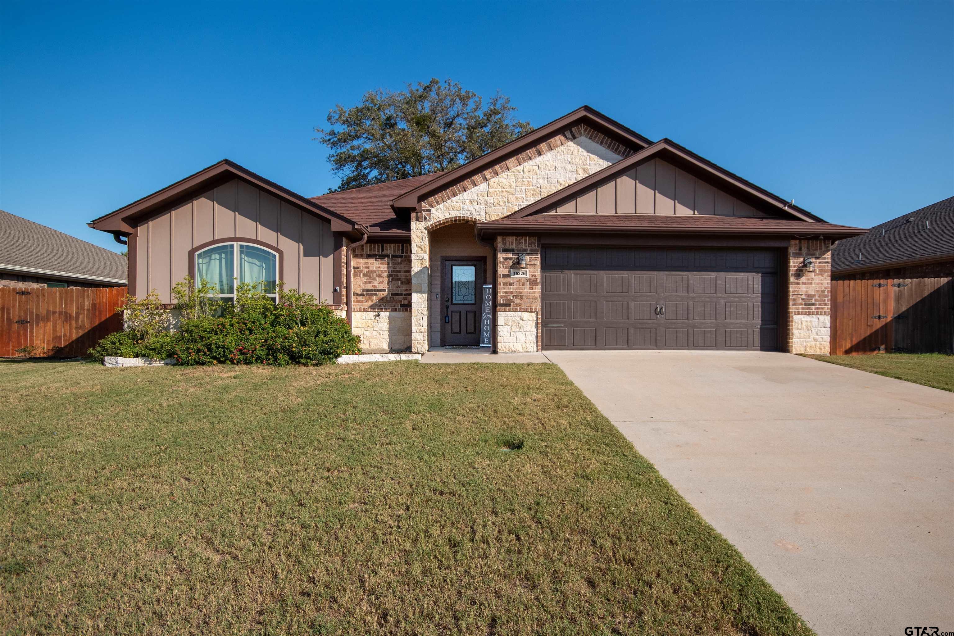 15326 Spring Oaks Drive Lindale, TX 75771 - Photo 1 of 29 a front view of a house with a yard and garage