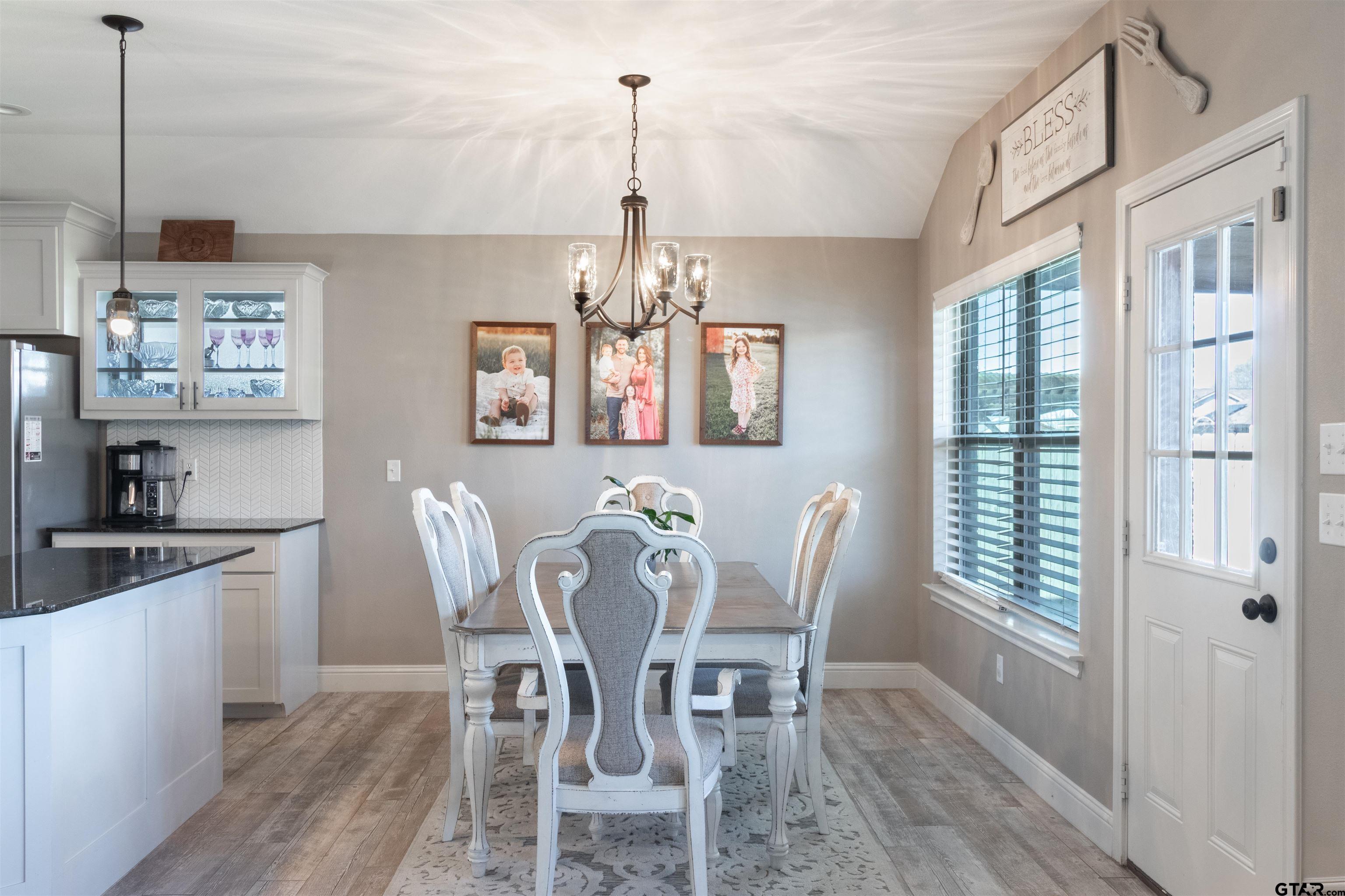 15326 Spring Oaks Drive Lindale, TX 75771 - Photo 13 of 29 a view of a dining room with furniture large window and wooden floor