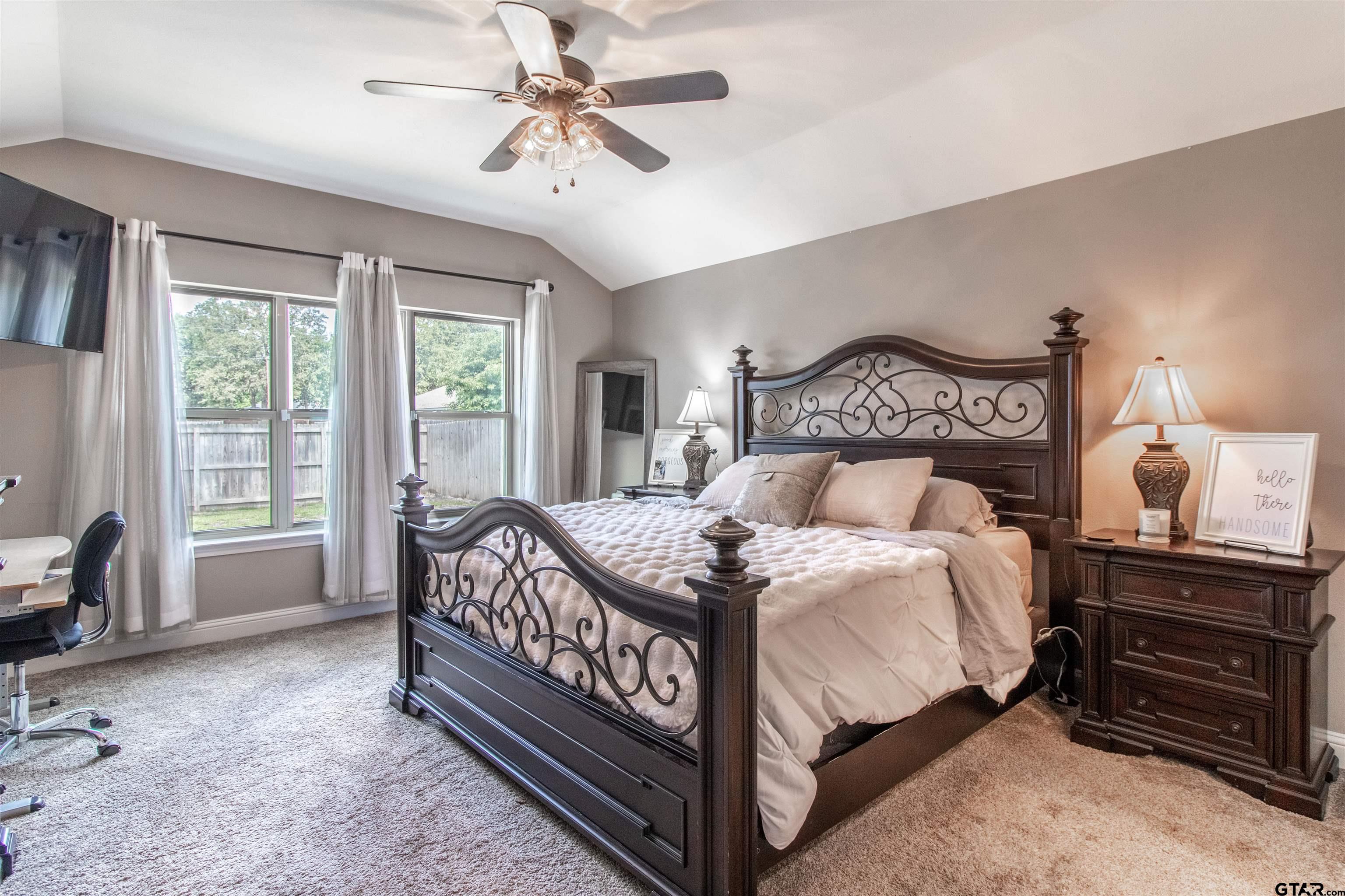 15326 Spring Oaks Drive Lindale, TX 75771 - Photo 16 of 29 a bedroom with a bed a chandelier and a dresser