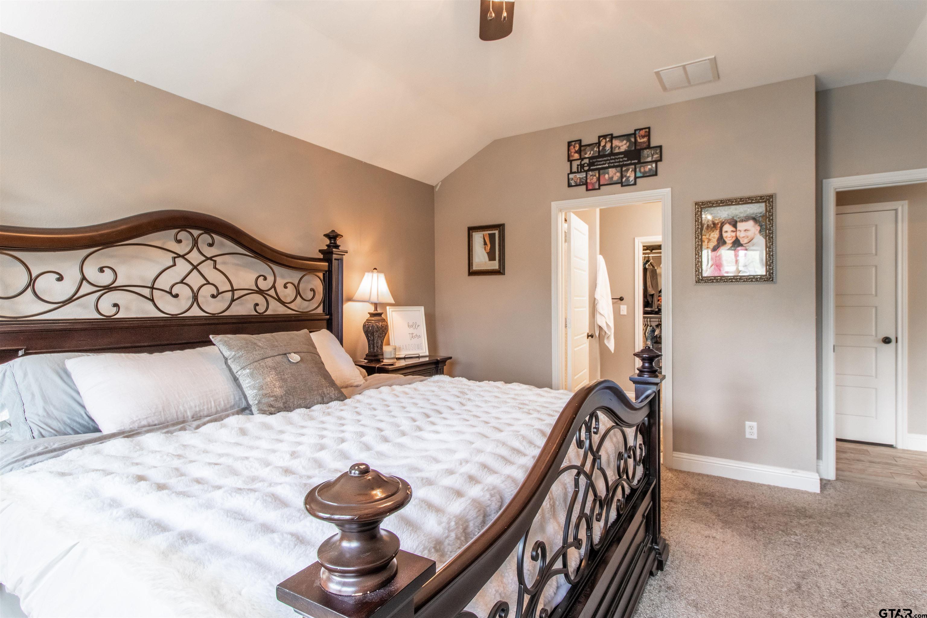 15326 Spring Oaks Drive Lindale, TX 75771 - Photo 17 of 29 a bedroom with a bed and a lamp on dresser