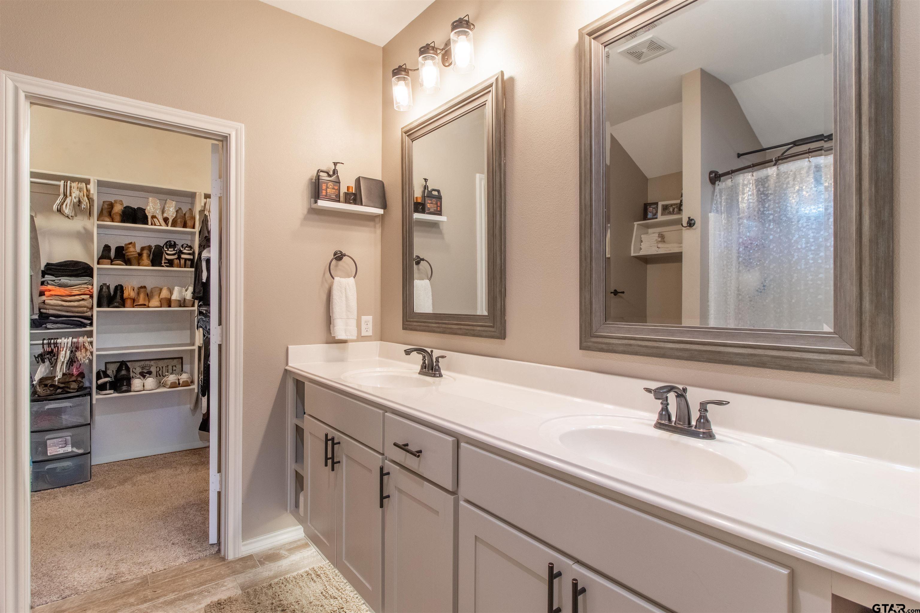 15326 Spring Oaks Drive Lindale, TX 75771 - Photo 18 of 29 a bathroom with a sink and a mirror