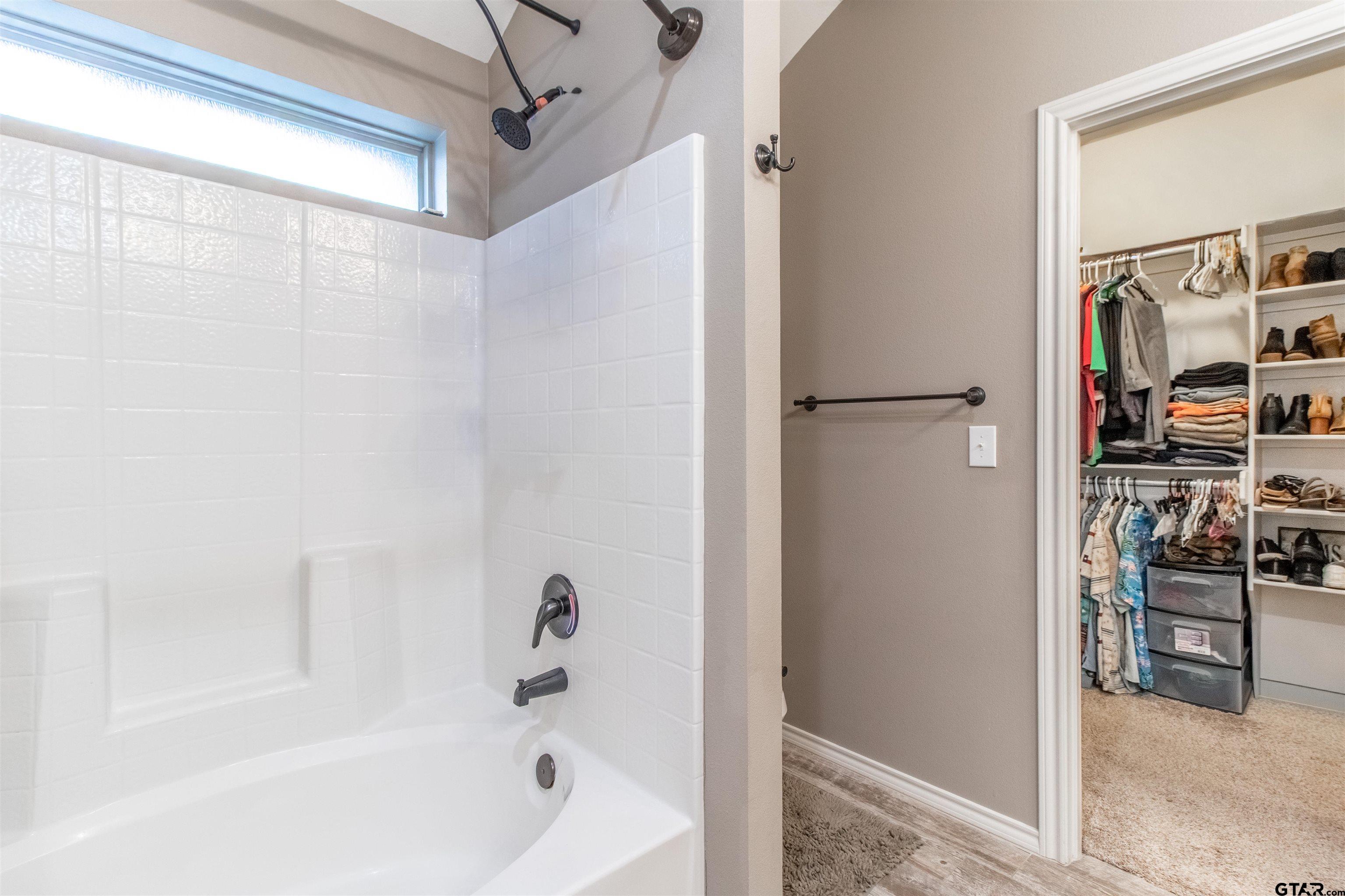 15326 Spring Oaks Drive Lindale, TX 75771 - Photo 19 of 29 a bathroom with a bathtub and a shower