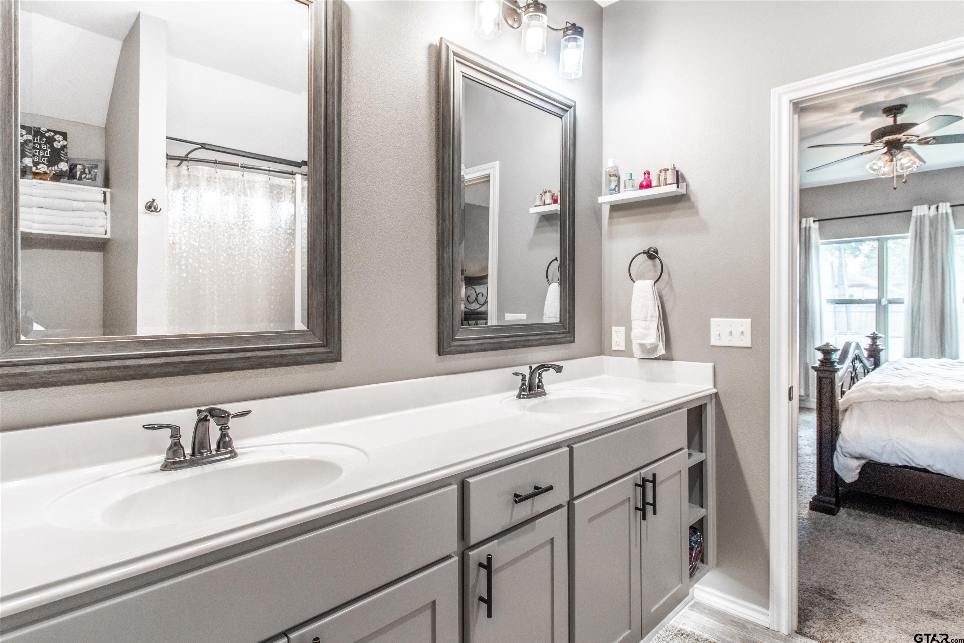 15326 Spring Oaks Drive Lindale, TX 75771 - Photo 20 of 29 a en suite bathroom with a double vanity sink and a mirror