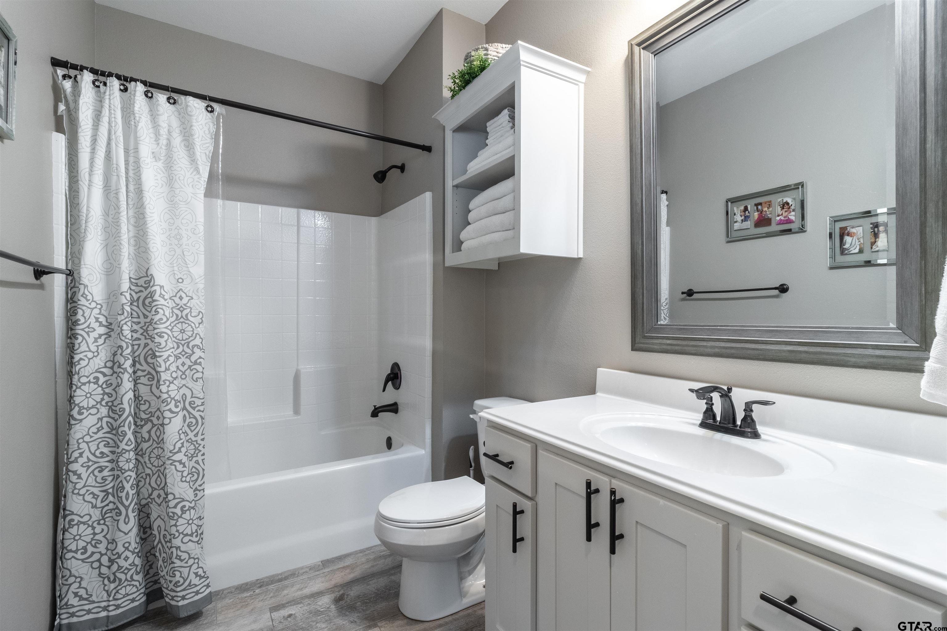 15326 Spring Oaks Drive Lindale, TX 75771 - Photo 22 of 29 a bathroom with a sink toilet and shower