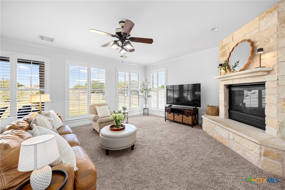 600 Lake Side Cove Georgetown, TX 78628 - Photo 22 of 48 a living room with furniture a flat screen tv and a fireplace