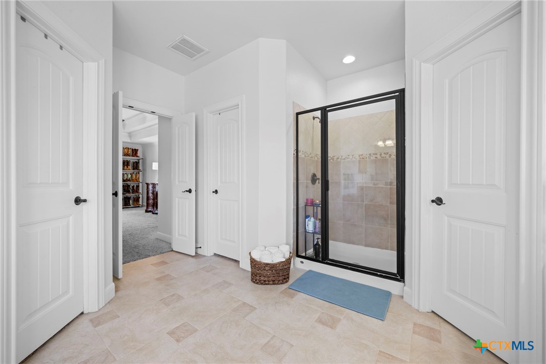 600 Lake Side Cove Georgetown, TX 78628 - Photo 38 of 48 a view of an empty room with glass door and a shower