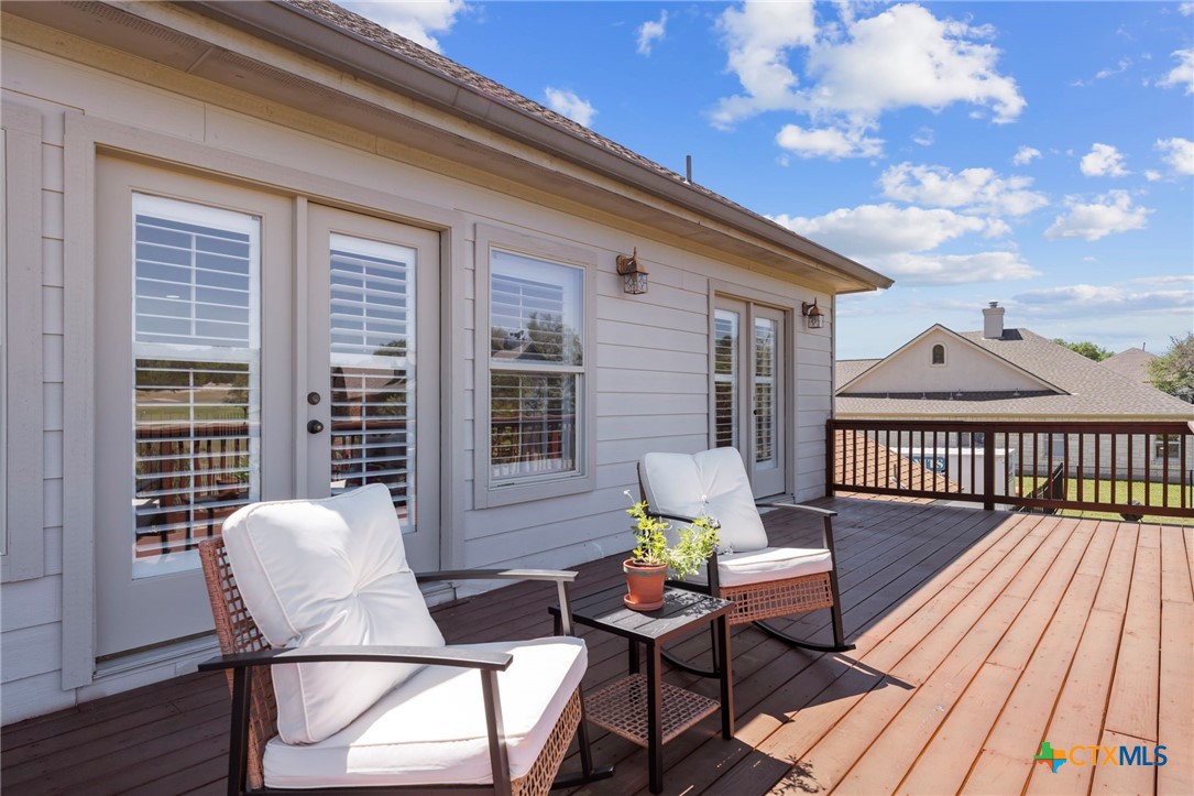 600 Lake Side Cove Georgetown, TX 78628 - Photo 39 of 48 a view of a deck with table and chairs and wooden floor