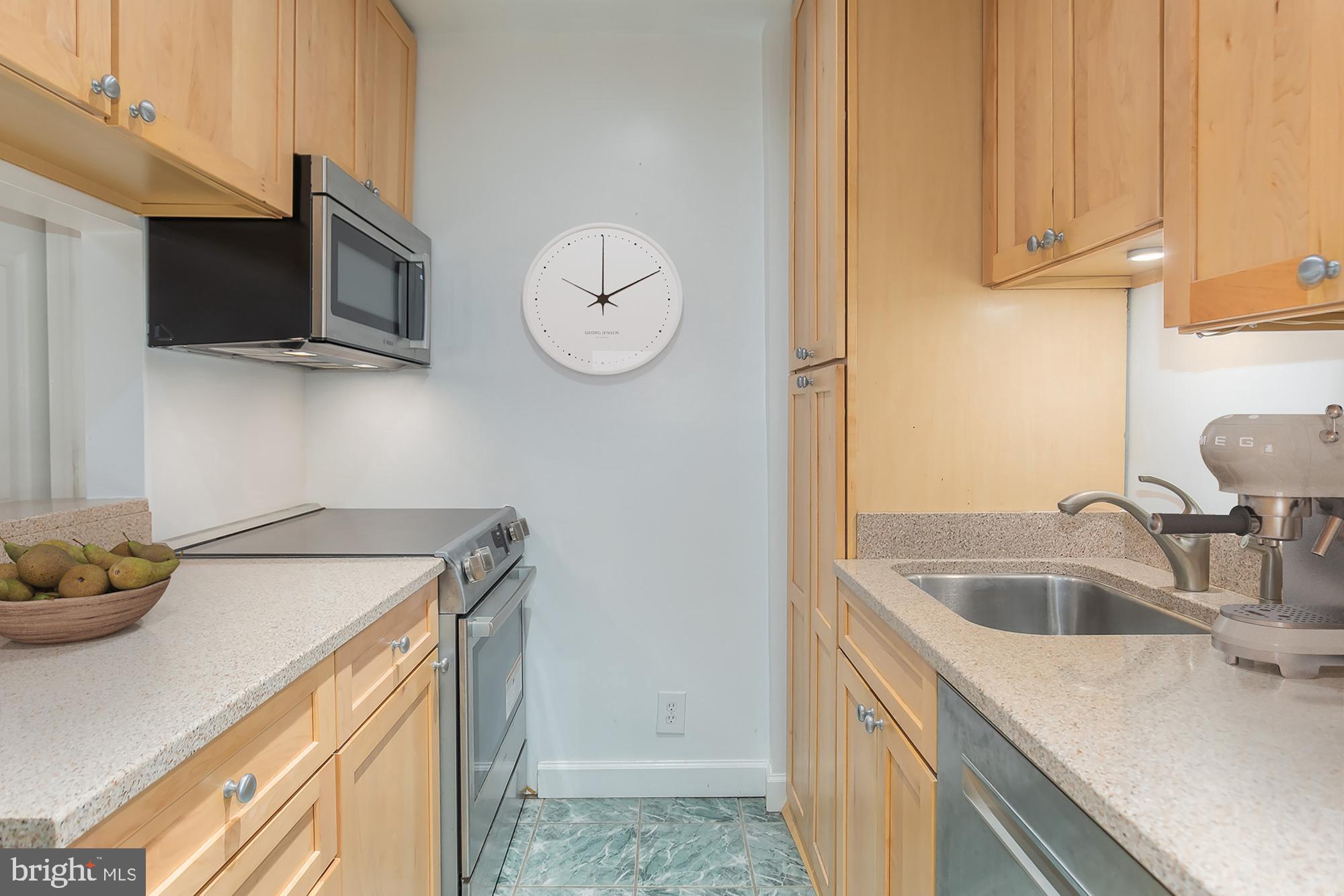 1316 New Hampshire Avenue Northwest, Unit 503 Washington, DC 20036 - Photo 12 of 24 a kitchen with stainless steel appliances granite countertop a sink and a microwave