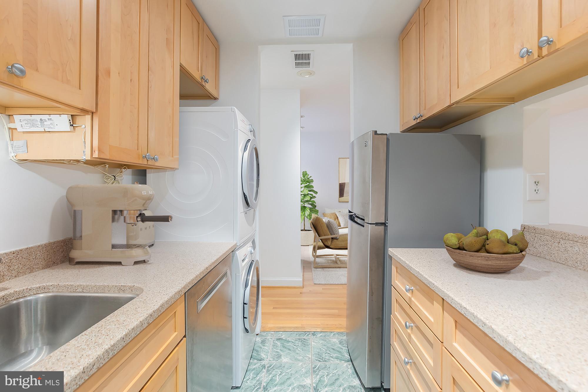 1316 New Hampshire Avenue Northwest, Unit 503 Washington, DC 20036 - Photo 16 of 24 a kitchen with stainless steel appliances a sink a refrigerator and a window