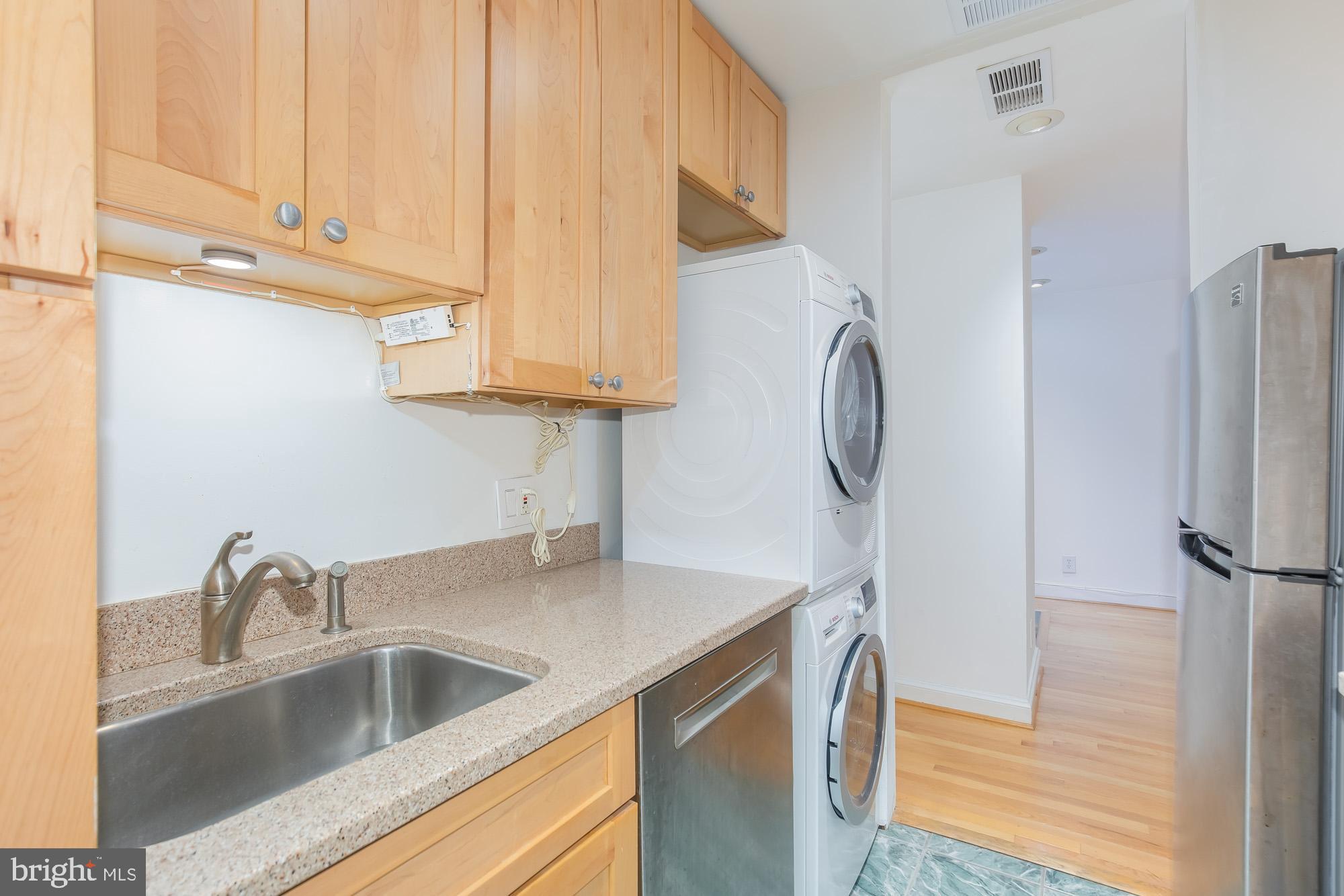 1316 New Hampshire Avenue Northwest, Unit 503 Washington, DC 20036 - Photo 17 of 24 a kitchen with stainless steel appliances granite countertop a sink and a refrigerator