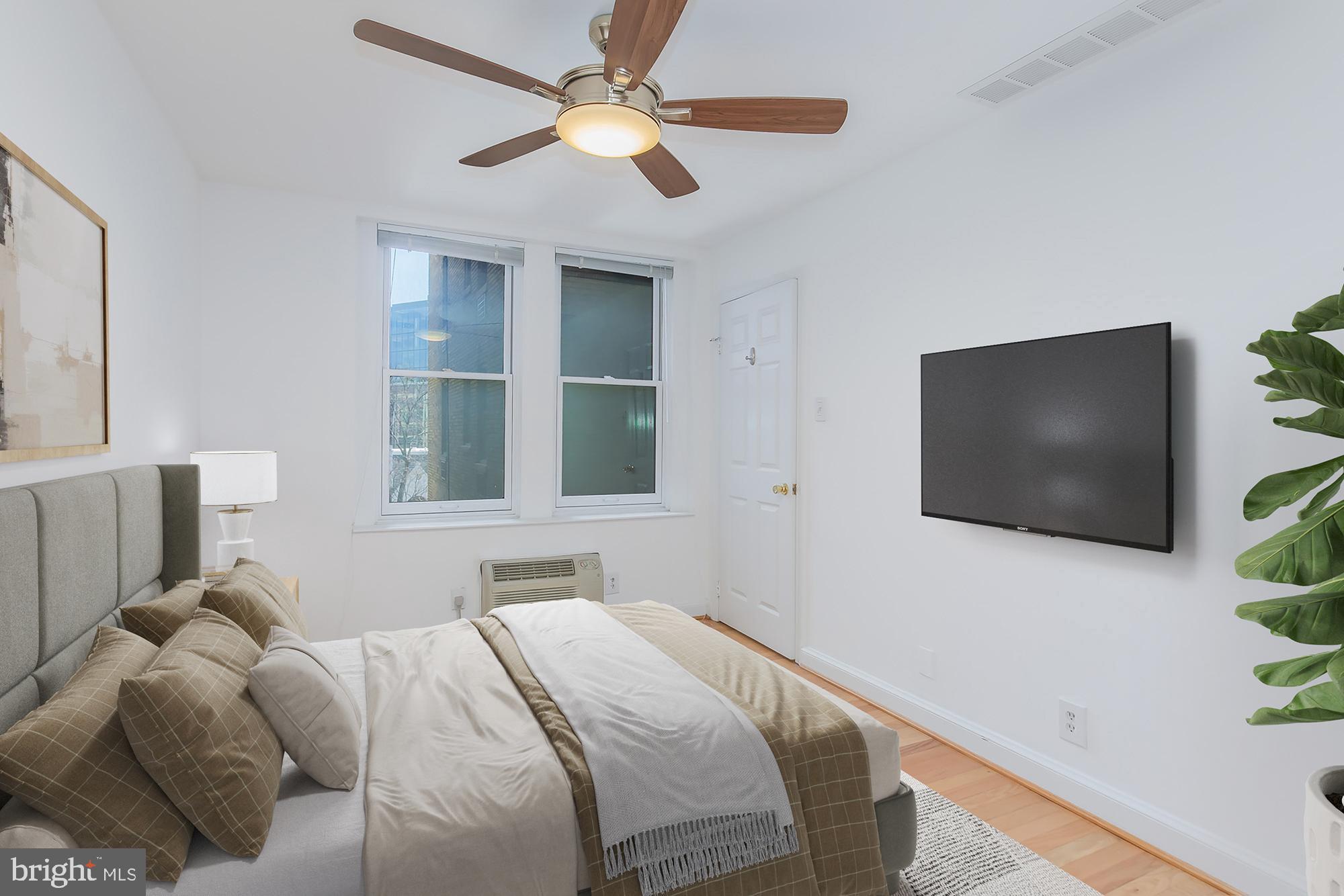 1316 New Hampshire Avenue Northwest, Unit 503 Washington, DC 20036 - Photo 19 of 24 a bedroom with a large bed and a flat screen tv