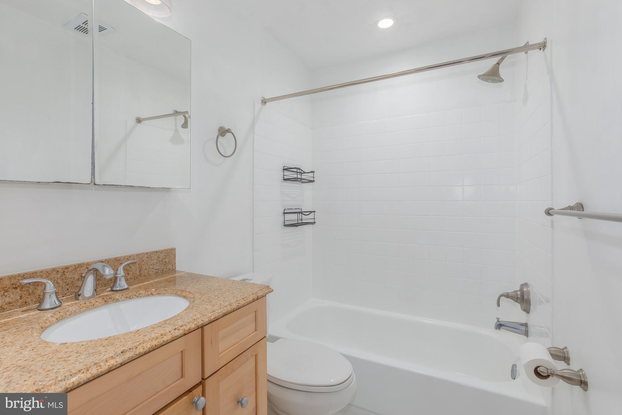 1316 New Hampshire Avenue Northwest, Unit 503 Washington, DC 20036 - Photo 20 of 24 a bathroom with a granite countertop sink toilet and shower