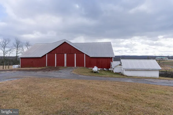 a living room with furniture a fireplace and a chandelier