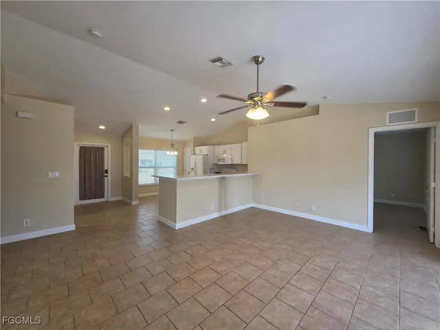 a view of a kitchen with a sink and a refrigerator