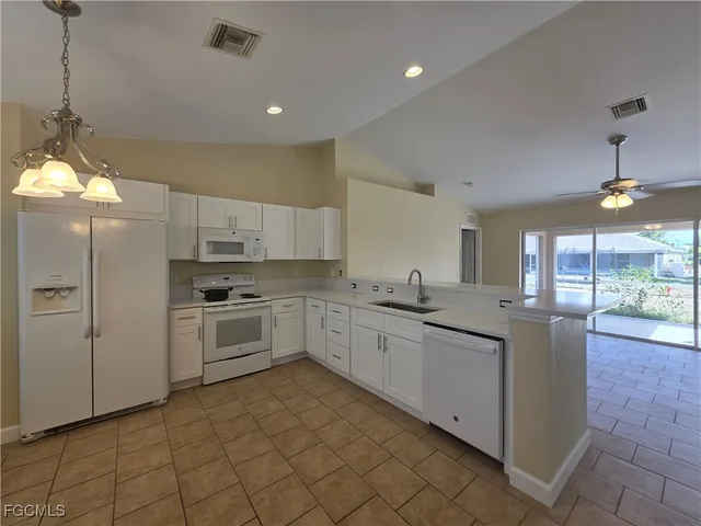 a kitchen with sink cabinets and window