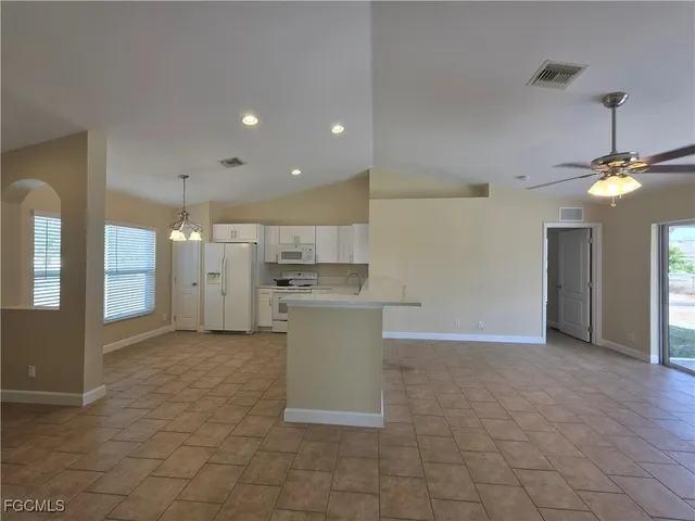 a view of a kitchen with a sink and a refrigerator