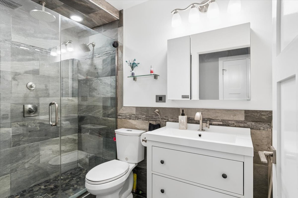 1109 Edson Avenue Lombard, IL 60148 - Photo 11 of 20 a bathroom with a toilet sink shower and mirror