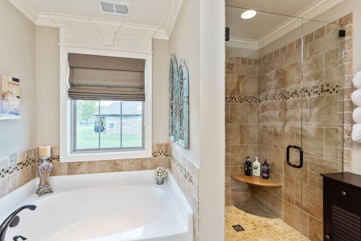 810 Burford Road Lebanon, TN 37087 - Photo 16 of 32 a bathroom with a tub a sink a window and a shower