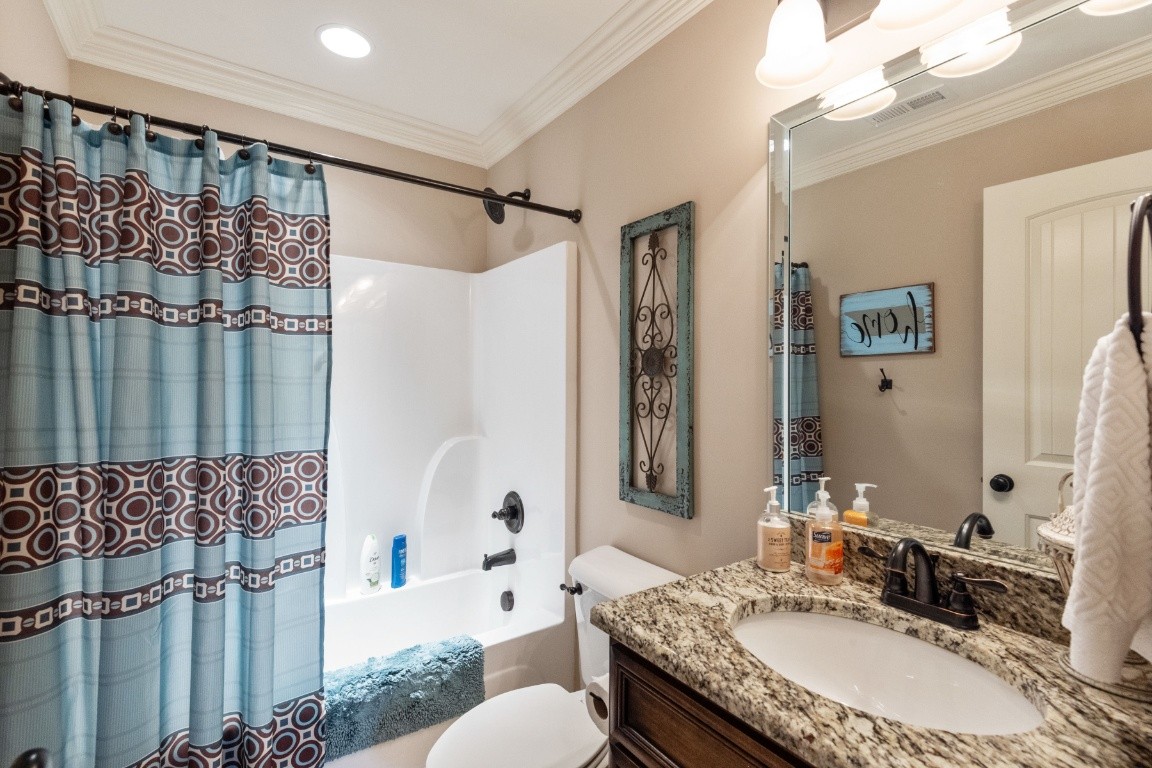 810 Burford Road Lebanon, TN 37087 - Photo 22 of 32 a bathroom with a granite countertop sink a mirror a toilet and shower