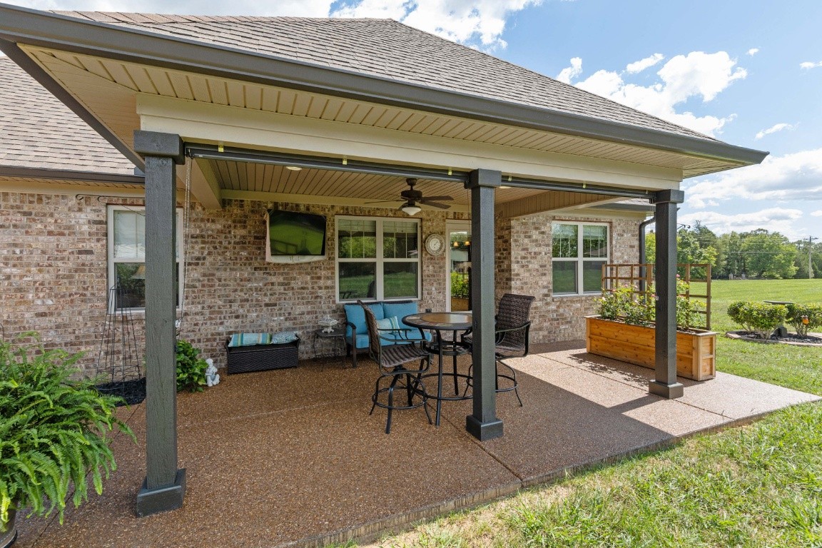 810 Burford Road Lebanon, TN 37087 - Photo 26 of 32 a view of a patio with table and chairs potted plants with wooden floor and fence