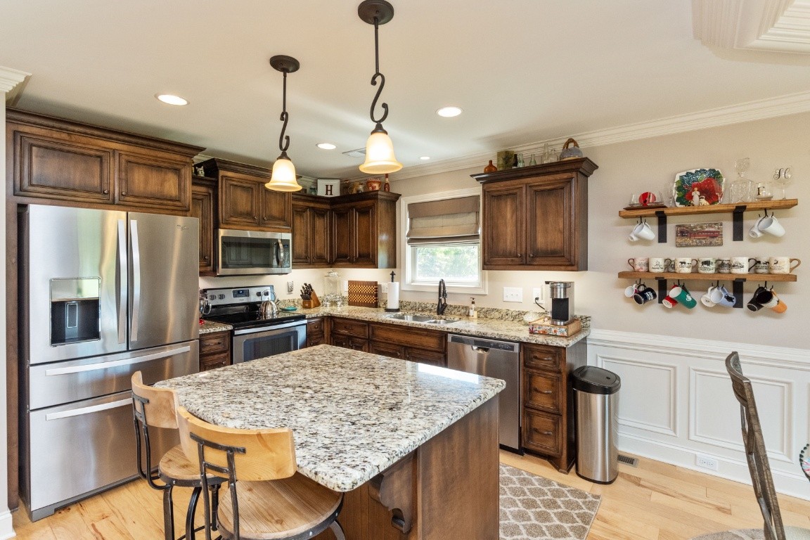 810 Burford Road Lebanon, TN 37087 - Photo 6 of 32 a kitchen with stainless steel appliances granite countertop a sink stove and refrigerator