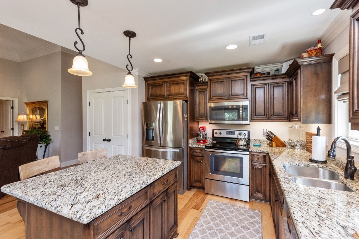 810 Burford Road Lebanon, TN 37087 - Photo 7 of 32 a kitchen with stainless steel appliances granite countertop a sink stove and refrigerator