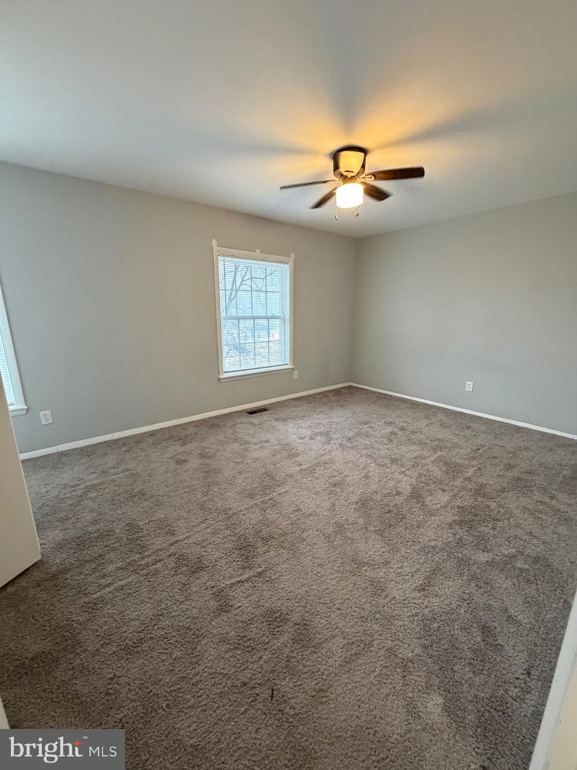 153 Hammershire Road, Unit C Reisterstown, MD 21136 - Photo 17 of 20 an empty room with windows and ceiling fan