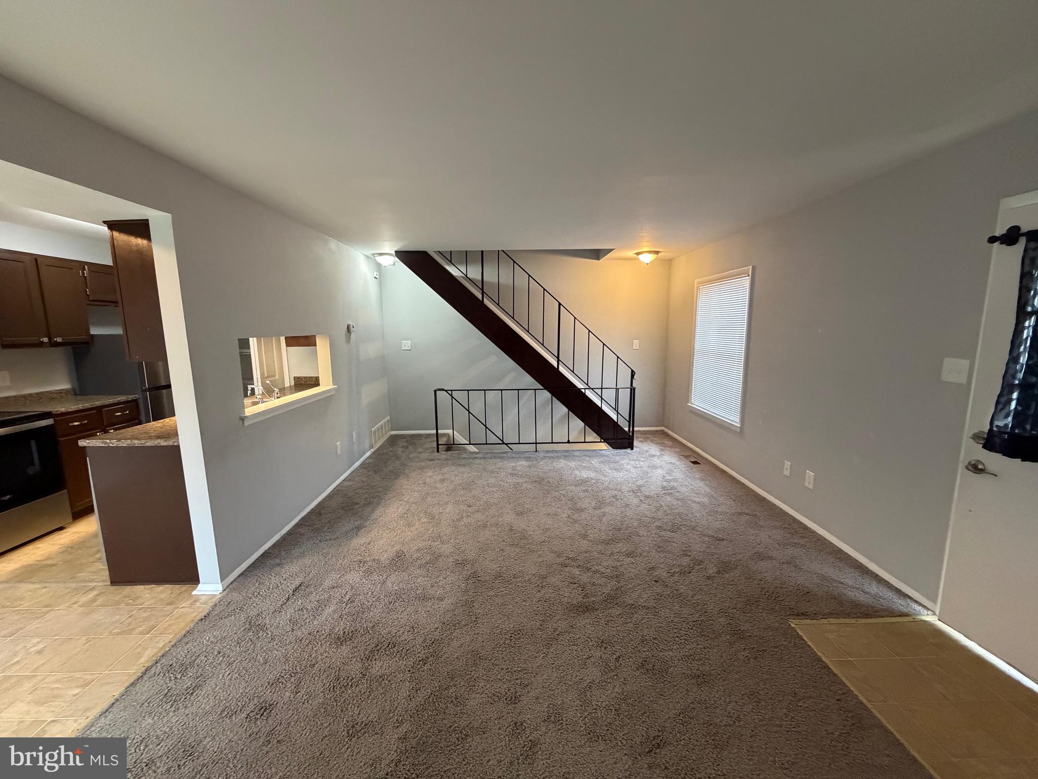 153 Hammershire Road, Unit C Reisterstown, MD 21136 - Photo 3 of 20 a view of a livingroom with wooden floor and stairs
