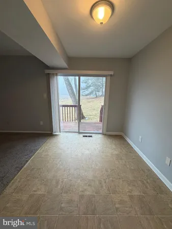a view of an empty room and a window