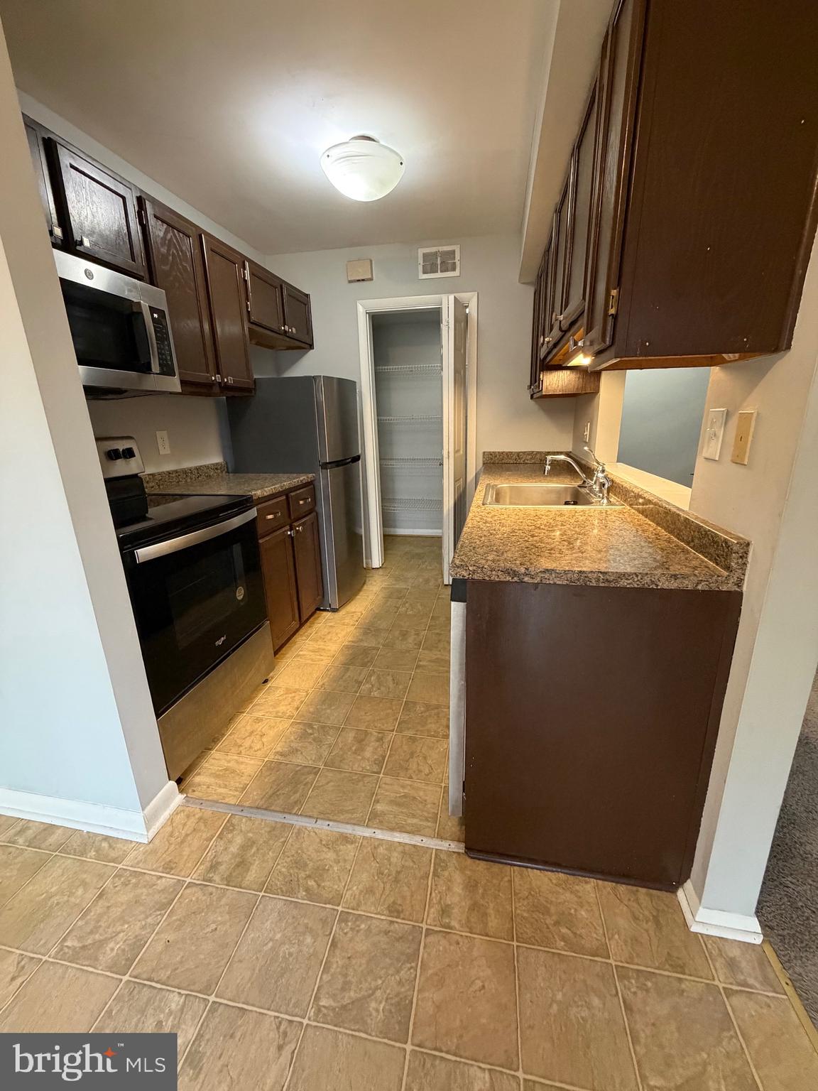 153 Hammershire Road, Unit C Reisterstown, MD 21136 - Photo 9 of 20 a kitchen with stainless steel appliances granite countertop a refrigerator and a stove