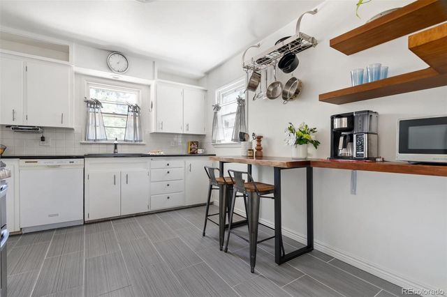 a kitchen with a sink cabinets and window