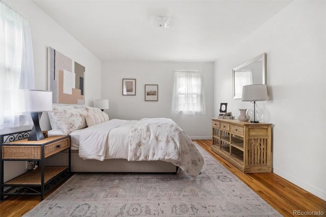 a spacious bedroom with a bed and a dresser in it