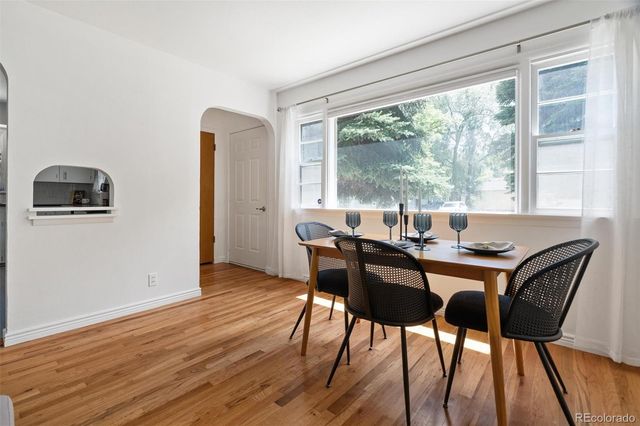 a view of a dining room with furniture window and wooden floor