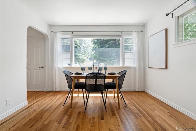 a view of a dining room with furniture window and wooden floor