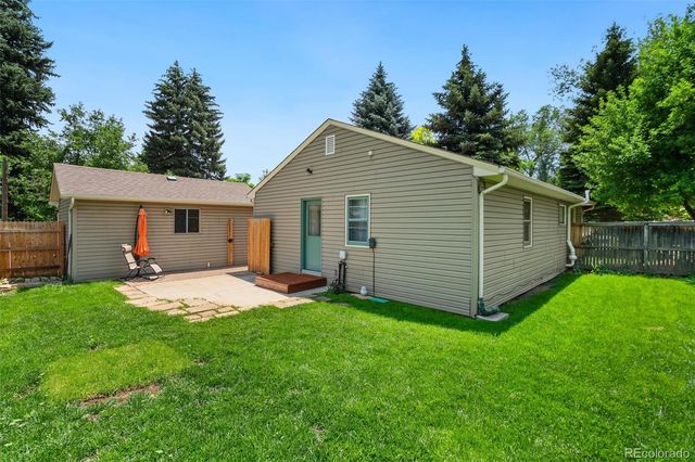 a front view of a house with yard and green space