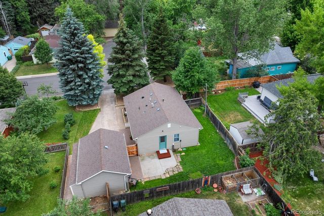an aerial view of multiple houses with yard