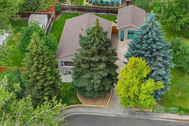 an aerial view of a house with garden space and street view