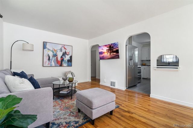 a living room with furniture and wooden floor