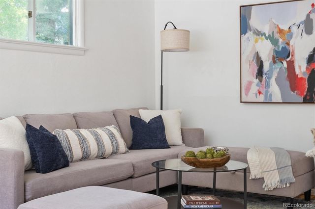 a living room with a couch and a painting on the wall