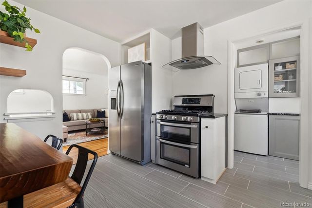 a kitchen with stainless steel appliances a stove a refrigerator and a refrigerator